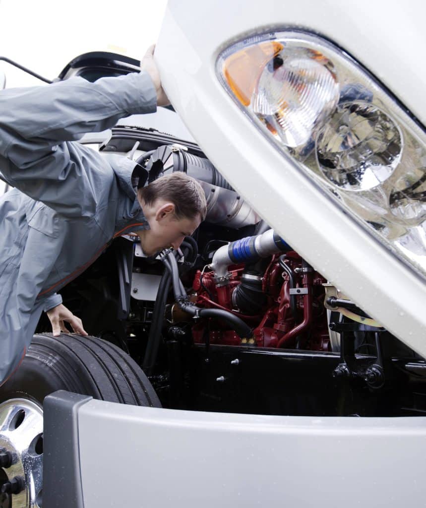 A mechanic examines truck but he needs a heavy-duty scan tool to properly diagnose the problem. This highlights the benefit of scan tools over code readers.
